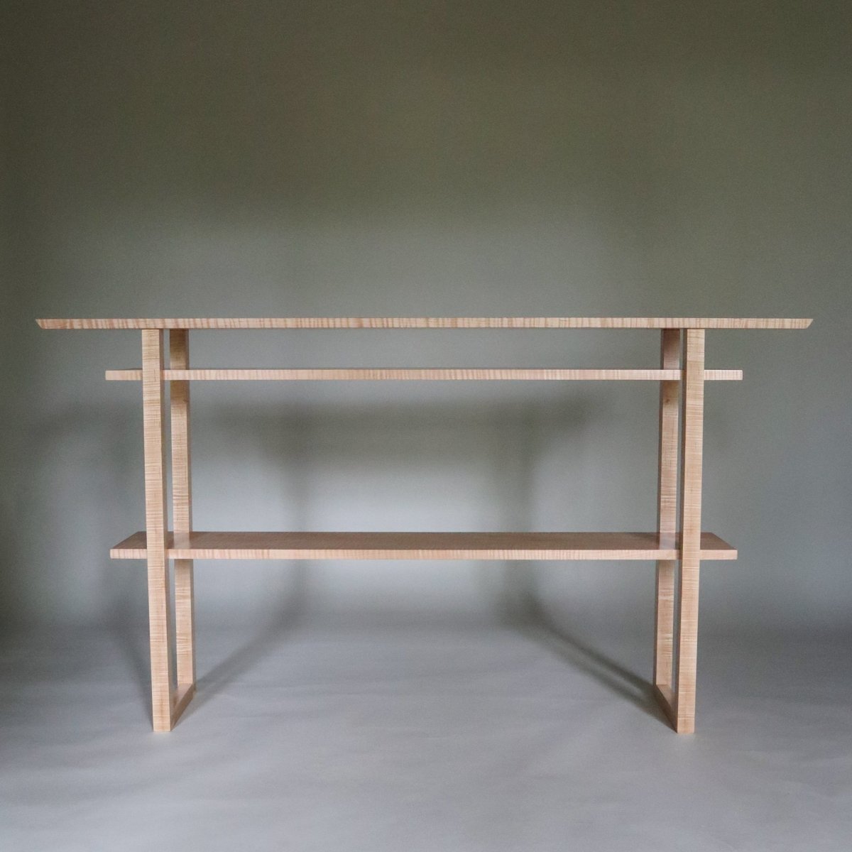 a modern hallway table with shelves.  Hand-crafted from tiger maple this modern console table is a unique narrow table size.  by Mokuzai Furniture