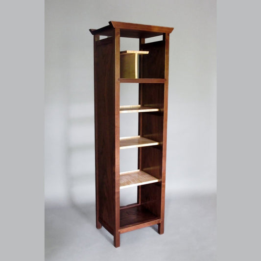 a narrow tall bookcase with open back by Mokuzai Furniture