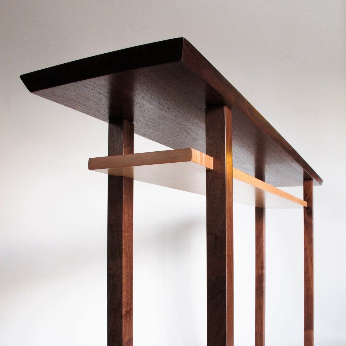 A modern wood furniture design, this skinny console table with shelf is perfect for your entryway table or hallway decorating.  Unique table designs from Mokuzai Furniture