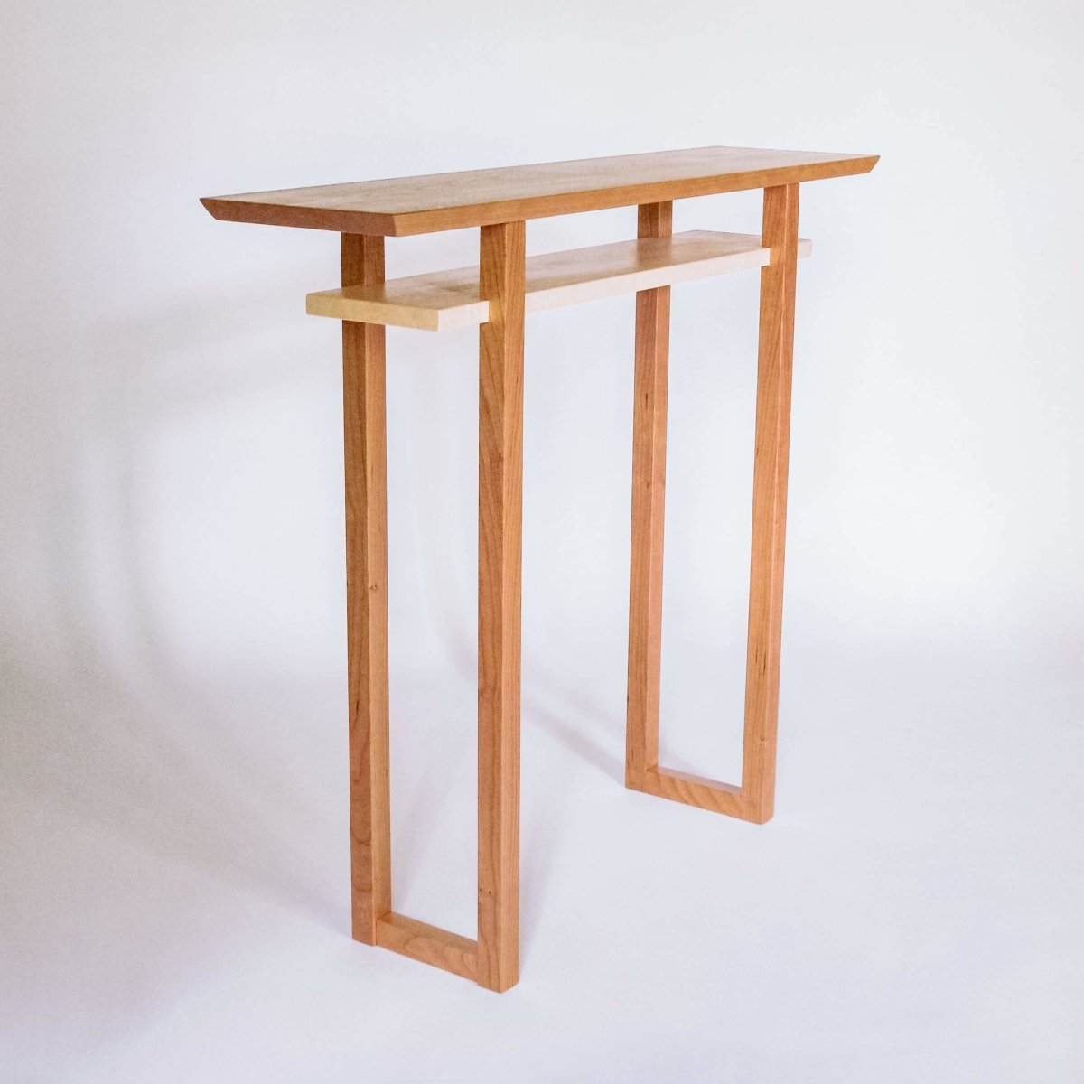 a small modern hall table handmade from cherry and tiger maple wood furniture designed by Mokuzai Furniture