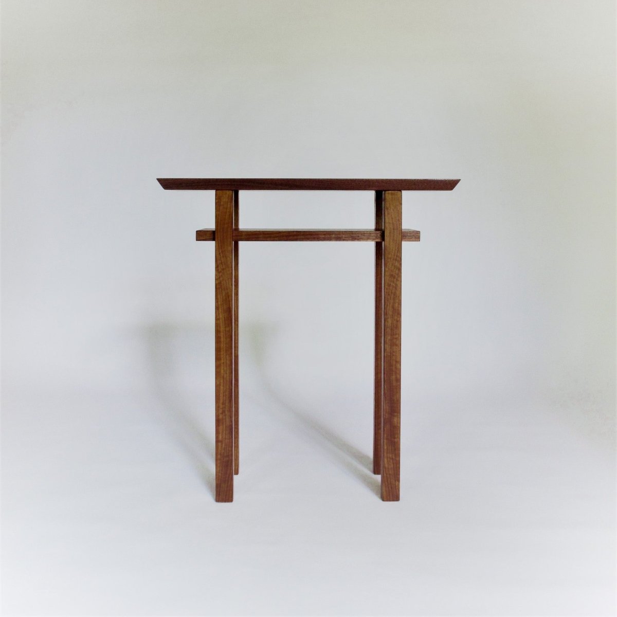 a small narrow wooden end table by Mokuzai Furniture.  This small end table has contemporary furniture lines and is handcrafted from only the most premium wood.
