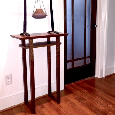 A small tall entry table handmade from solid walnut by Mokuzai Furniture.