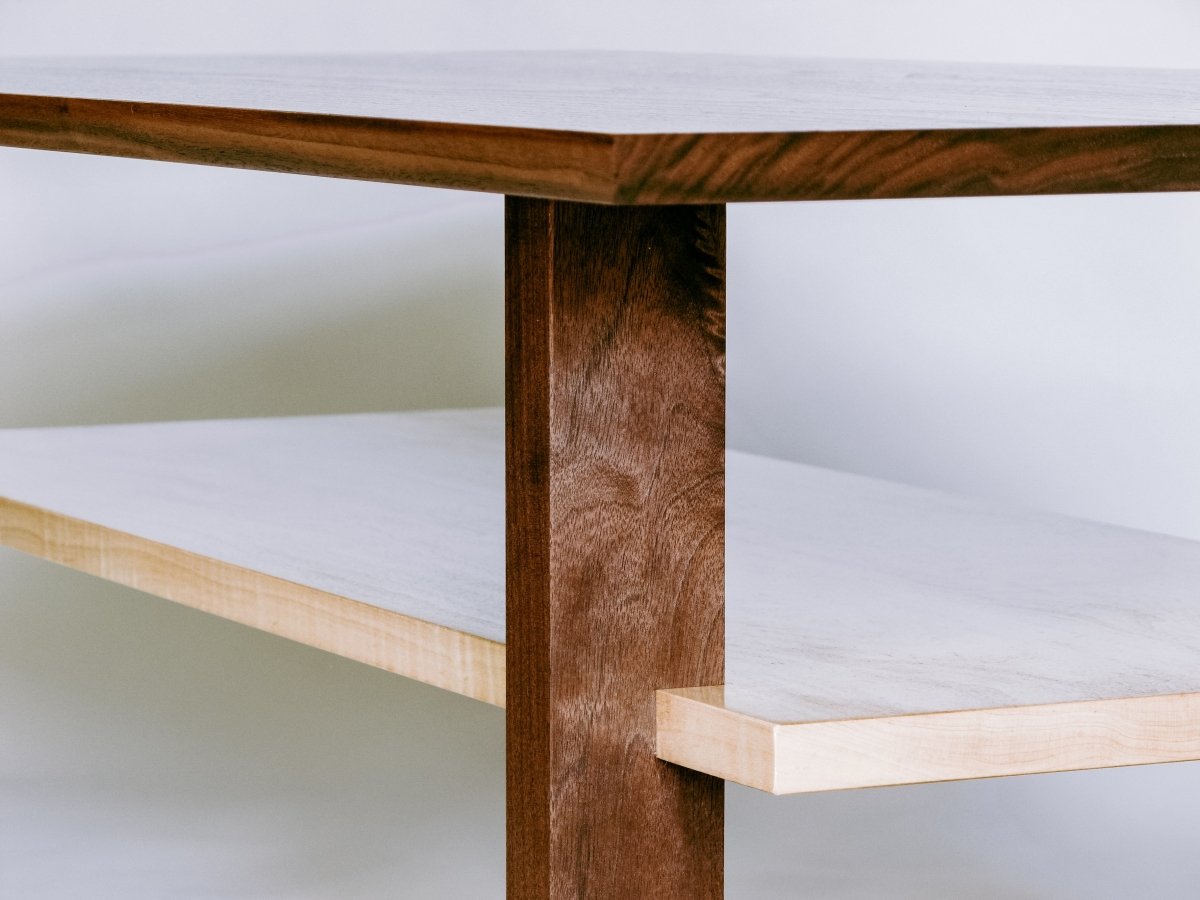 The shelf of this wooden coffee table is part of an interesting joinery detail where it is set into the legs.  our fine wood furniture is hand-crafted from premium solid wood with heirloom quality furniture techniques. modern coffee table design by Mokuzai Furniture