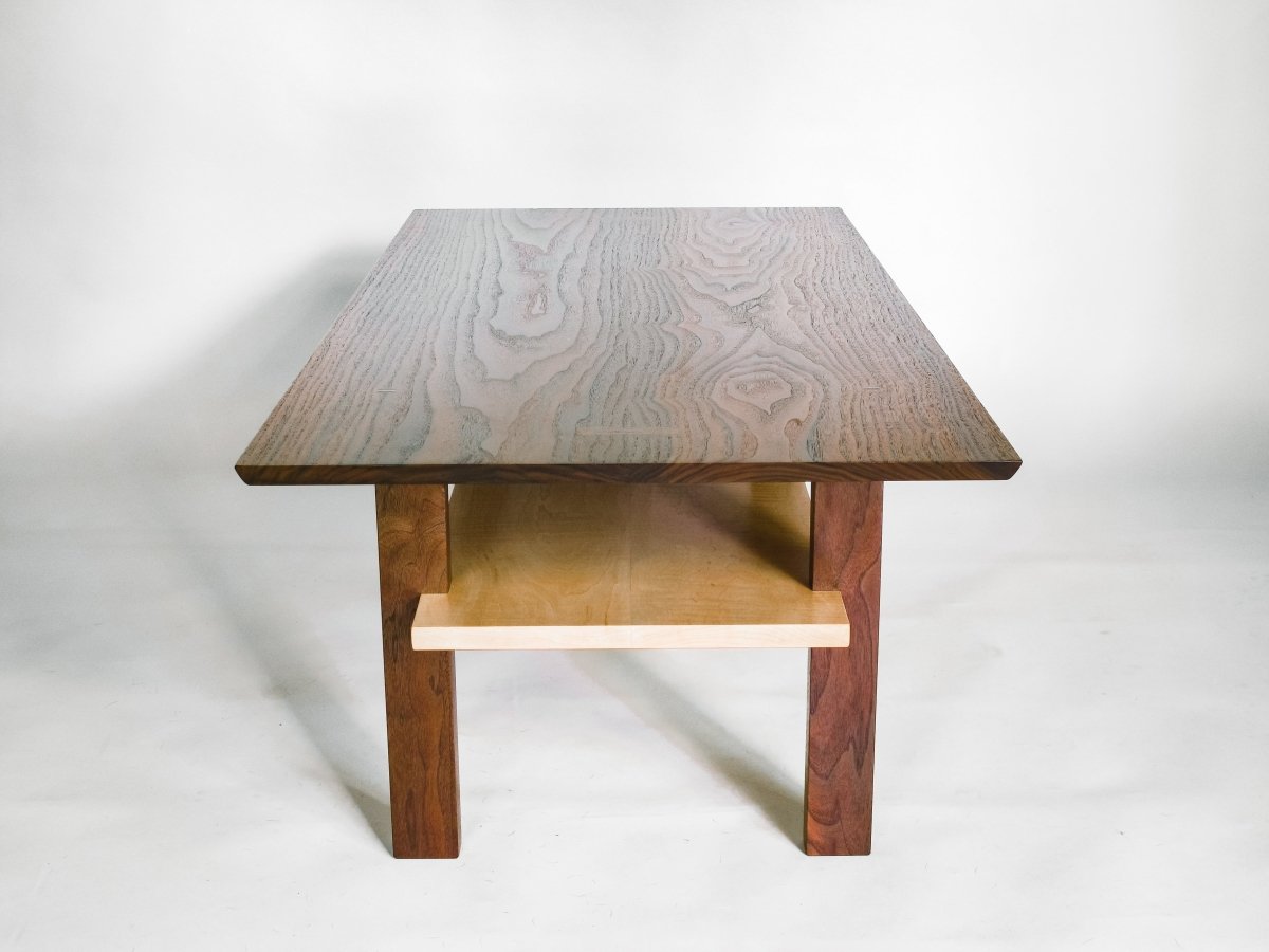 a beautiful walnut living room table, this narrow coffee table with storage has a tiger maple shelf.  Modern wood furniture design by Mokuzai Furniture