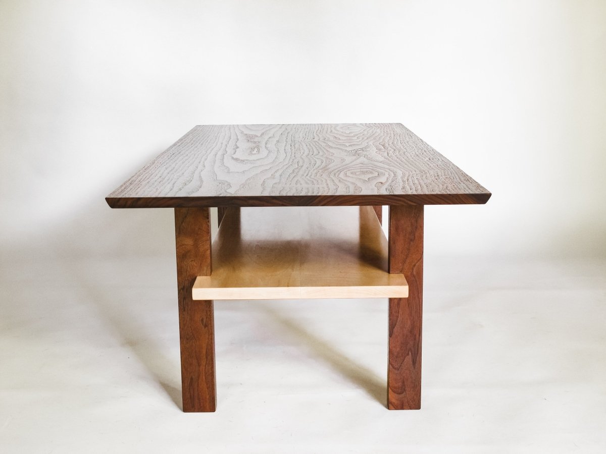 a narrow coffee table for small living room decor.  modern coffee table design created from walnut and tiger maple.  hand-crafted coffee table by Mokuzai Furniture