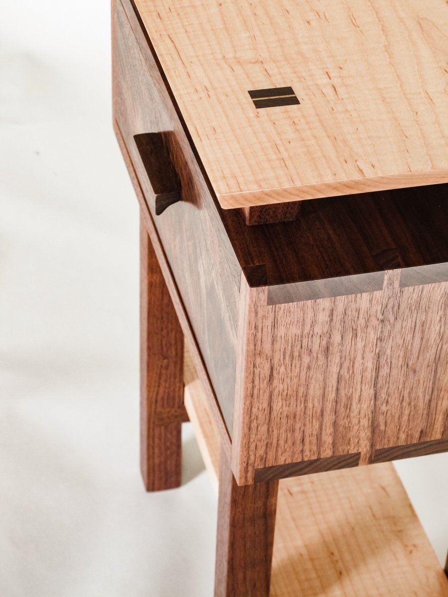 Hand-cut dovetails featured at the sides of our Encore Nightstand- a small wooden table with drawer