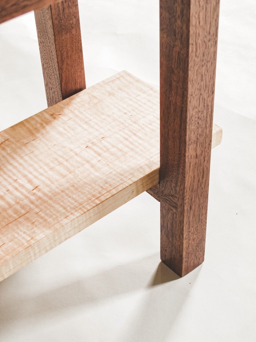 Hand-cut dovetails support the shelf on this walnut and tiger maple bed side table