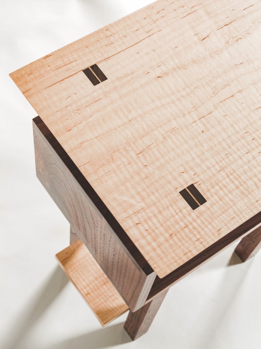 Walnut with tiger maple wedge detail in the table top of our Encore Nightstand - fine wood furniture for the bedroom or small end table