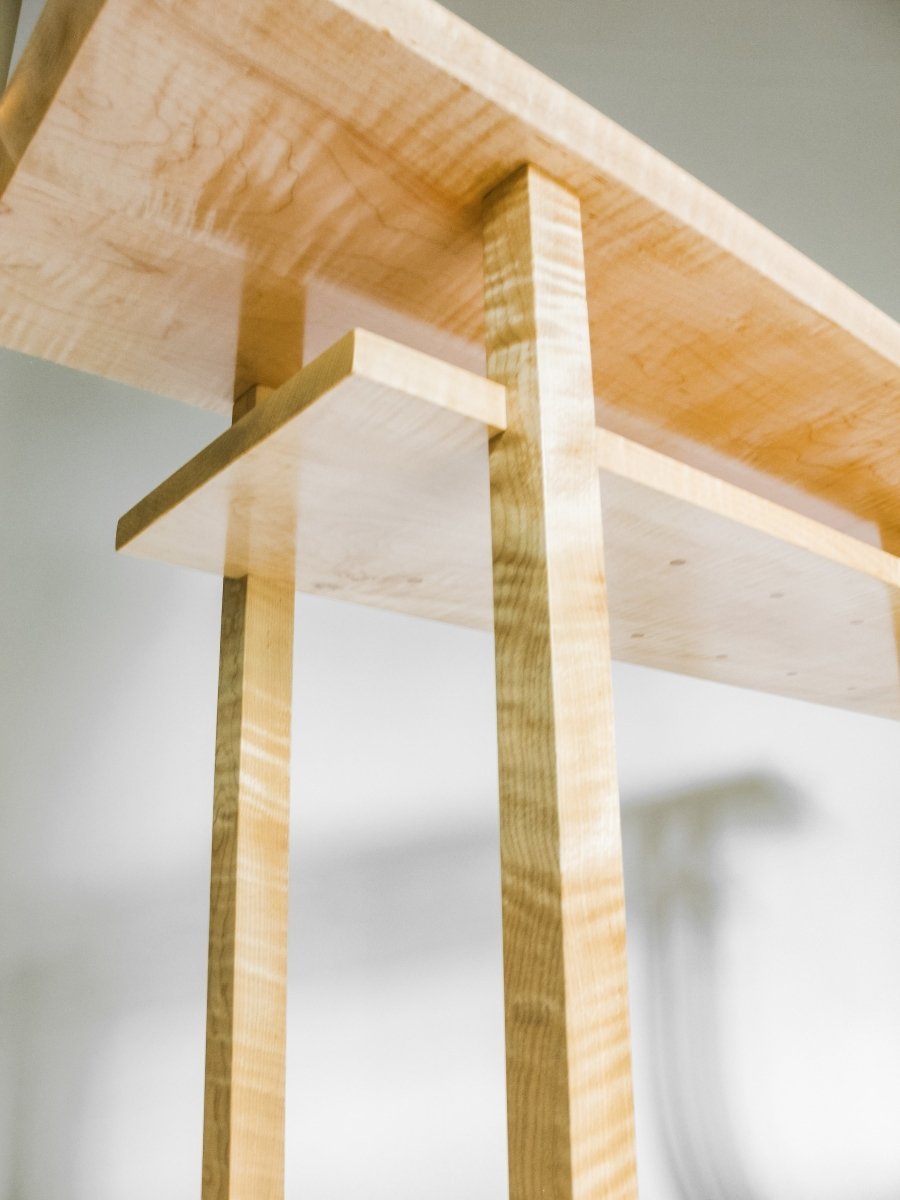 hand-cut joinery detail at inset of the shelf into the legs of this dining room side table with wine rack storage - modern wood furniture design by Mokuzai Furniture