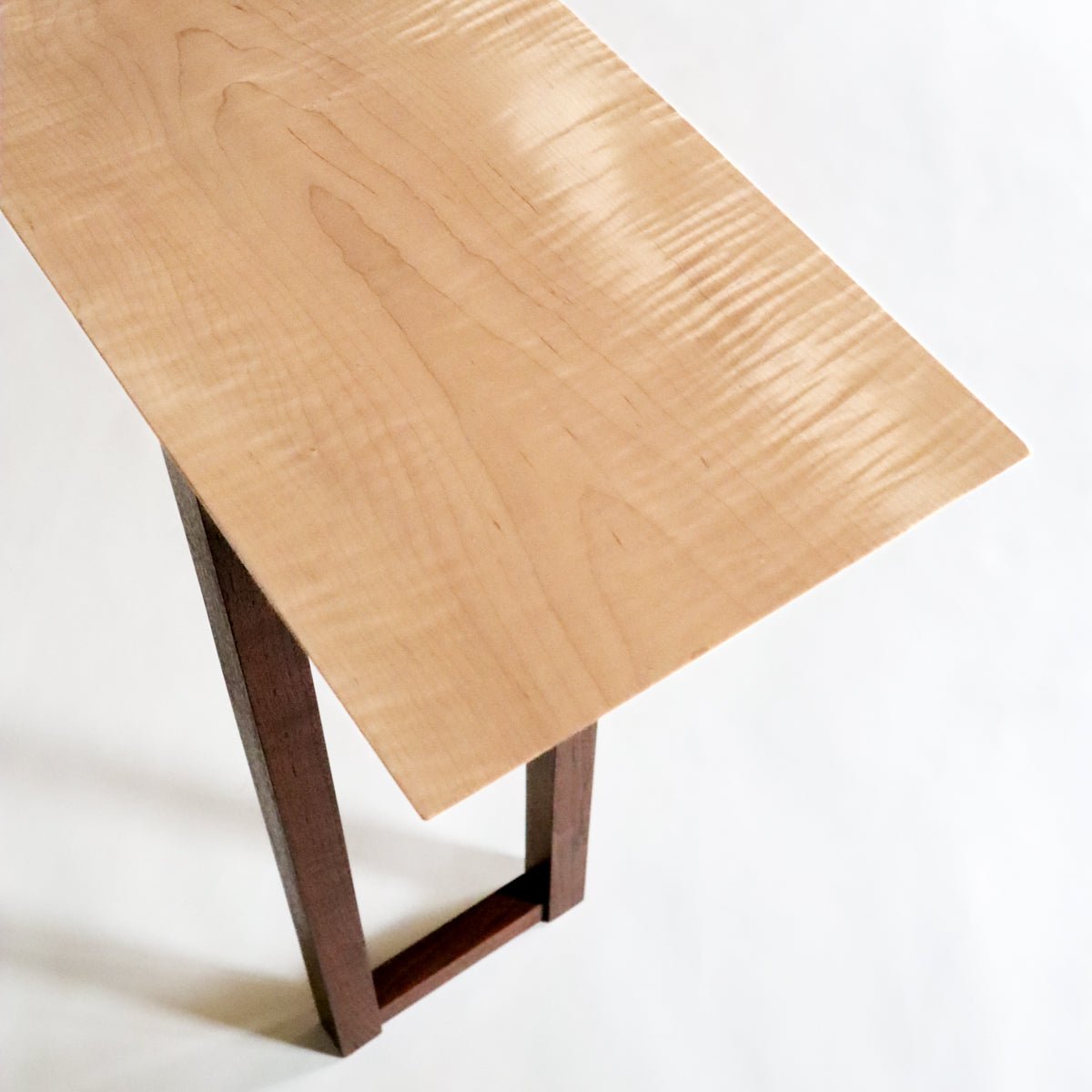 This is a tiger maple table top on a skinny console table created by Mokuzai Furniture.