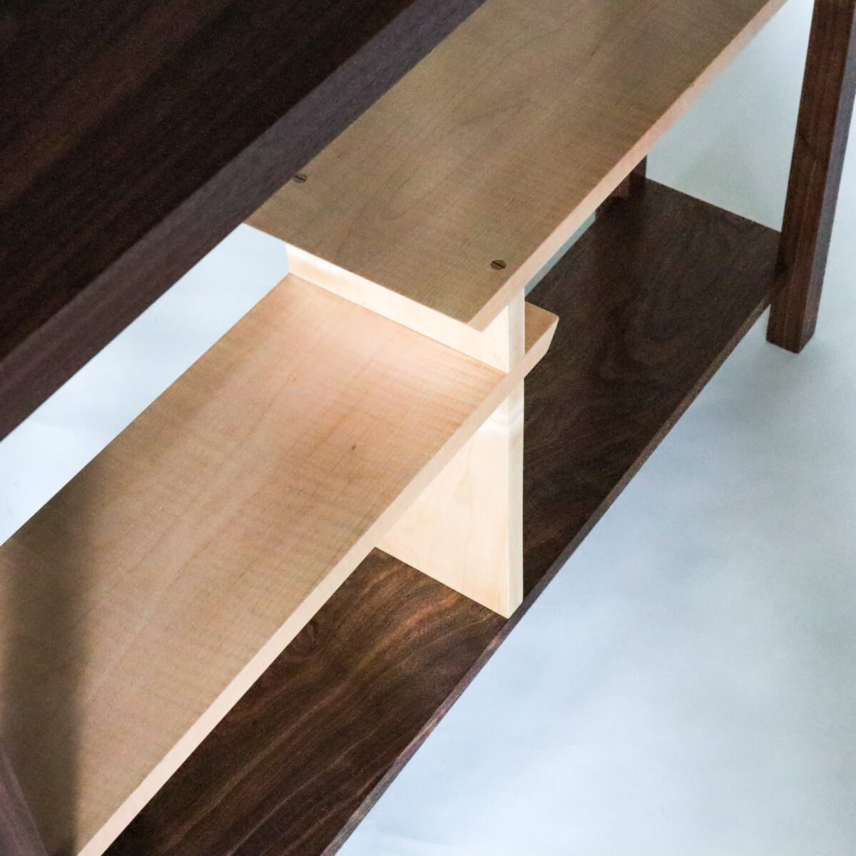 tiger maple display shelves on a narrow console table by Mokuzai Furniture