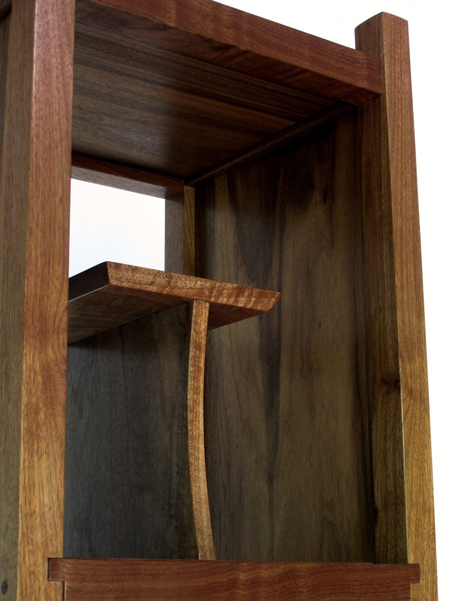 unique display case in walnut at the top of a tall narrow storage cabinet by Mokuzai Furniture